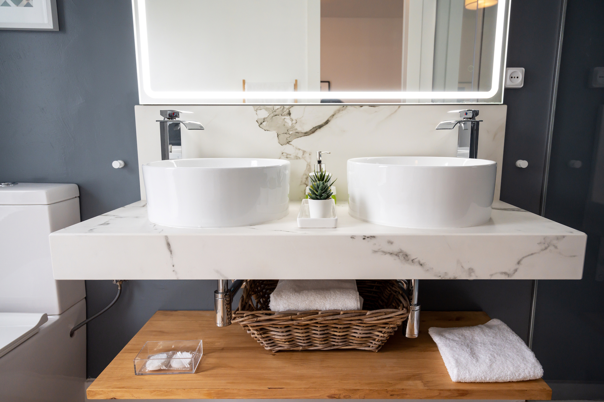 Interior of light modern bathroom with a mirror with light
