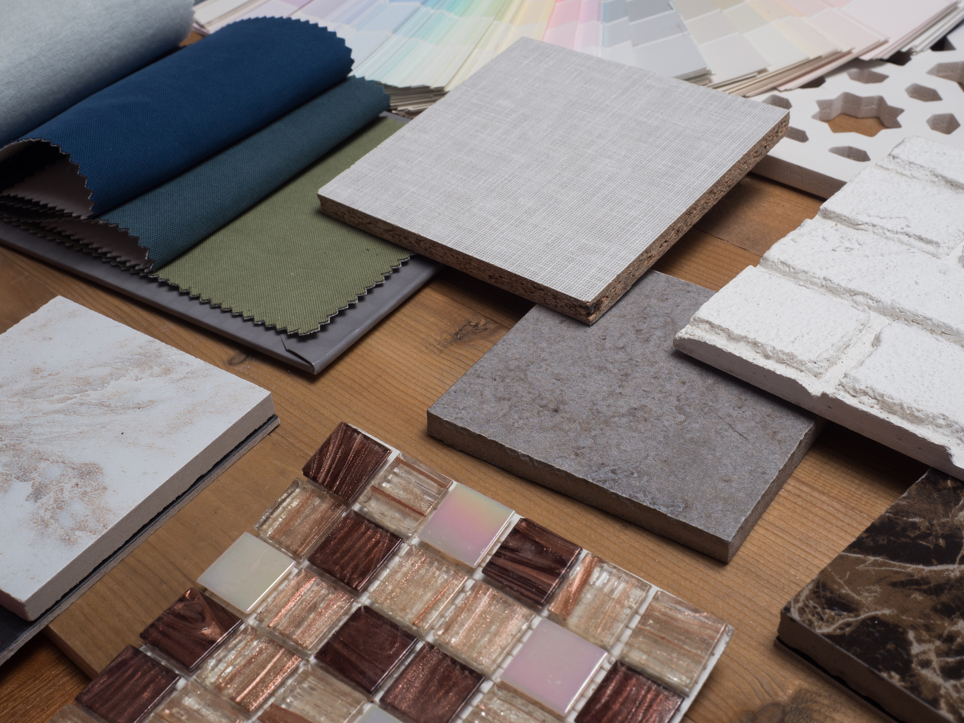 samples of material, wood , color , fabric curtain ,ceramic , on wooden table.Interior design select material for idea.